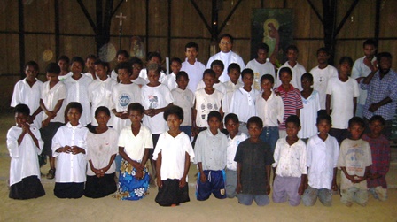 Children in the jungle "bush" of Papua New Guinea rejoice together after receiving their First Holy Communion.