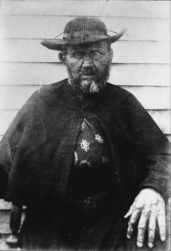 Saint Damien of Molokai, taken in 1889, weeks before his death, by photographer William Brigham, at a side wall on the Hawaiian colony for lepers at Saint Philomena Catholic Church.