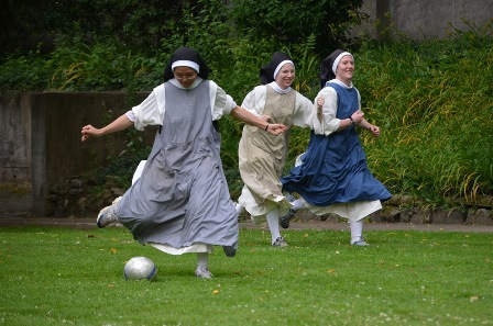Young Dominican nuns in full habit, from the Monastery of Our Lady of the Rosary in Summit, New Jersey, enjoy a game of soccer.