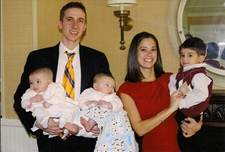 A beautiful young family joyfully celebrate the baptism of their twin babies.