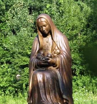 This beautiful statue, at the Shrine of Our Lady of Guadalupe in La Crosse, Wisconsin, shows the Blessed Virgin Mary holding three small babies in the fold of her mantle.