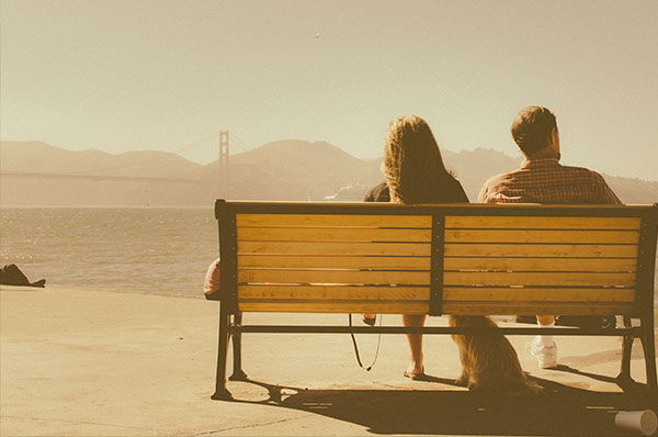 A husband and wife can communicate with each other just by sitting together in silence on a park bench.